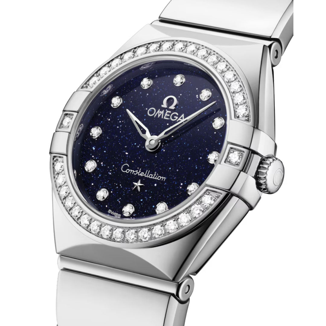 The OMEGA Constellation Quartz 25mm Watch features a diamond-paved bezel, silver band, and deep blue aventurine dial with diamond hour markers, accented by the OMEGA logo and "Constellation" on its elegant face.