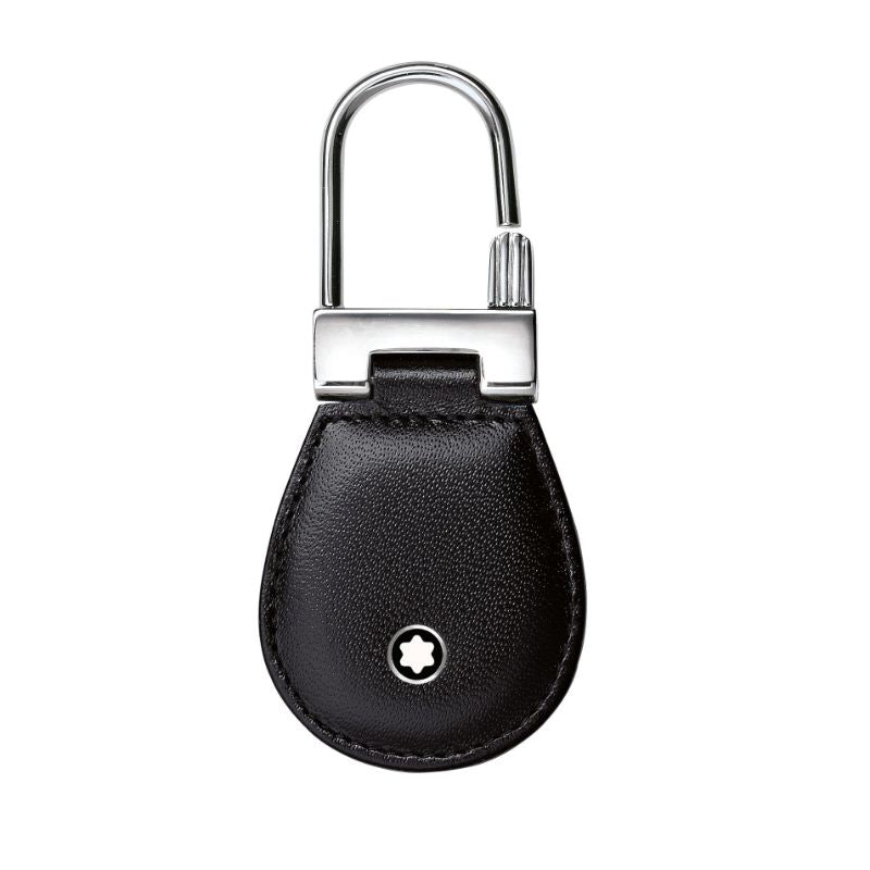 The Montblanc Meisterstuck Key Fob is an elegant and sophisticated accessory, expertly crafted from full-grain cowhide in a sleek black leather finish. It proudly showcases the iconic Montblanc star logo at its center, accompanied by a polished silver-tone metal clasp at the top, making it a refined and stylish addition for any occasion.