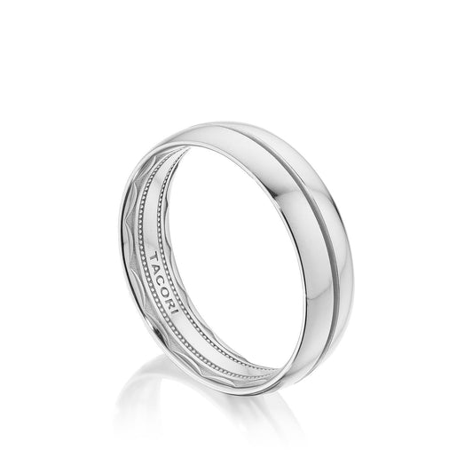This Tacori Classic Streamline wedding band, crafted in high polish 18K white gold, showcases a sleek and modern design with a subtle groove around the center. It features Tacori's signature sculpted crescent on the inside and provides a comfort fit that impeccably blends style and elegance.