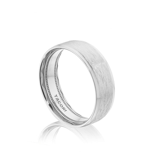 The Tacori Classic Bevel Edge Brushed Finish 18K White Gold Wedding Band features a brushed texture and a soft-comfort fit interior, engraved with the "Tacori" brand name and displayed against a plain white background.