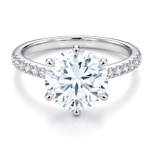 The Raffi&Co.® 14K White Gold Round Brilliant Diamond Halo Engagement Ring features a brilliant round center diamond and sparkling accent diamonds along the band, all in an elegant setting by Raffi&Co.