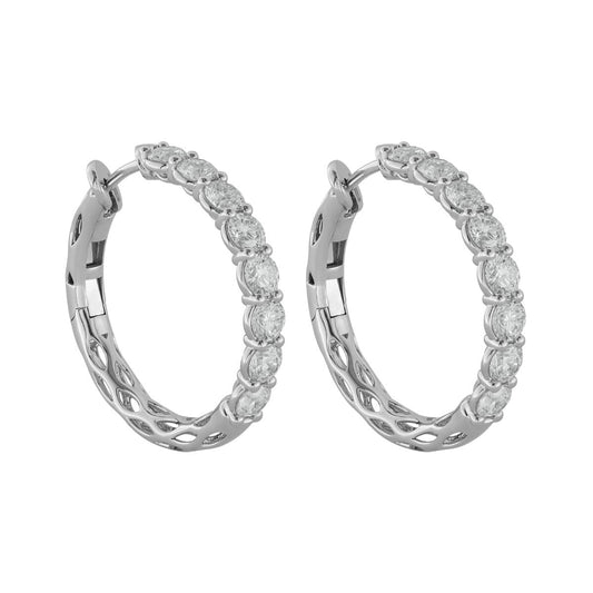 A pair of silver hoop earrings adorned with sparkle-encrusted stones. Featuring a hollow lattice design on the outer edges, these Raffi&Co.® 14K White Gold Diamond Hoop Earrings offer a blend of timeless elegance and contemporary style.