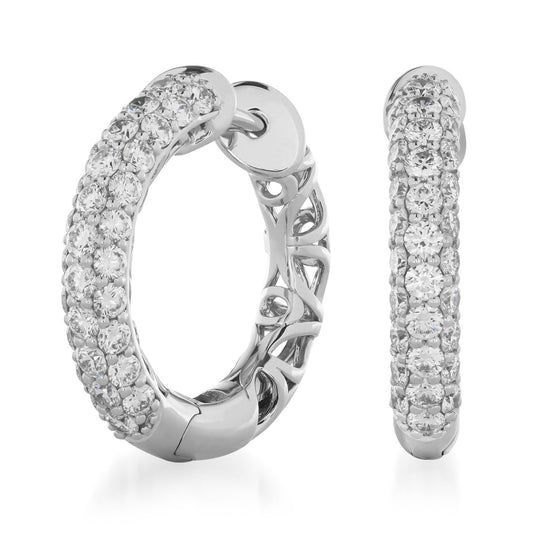 The Raffi&Co.® 14K White Gold Diamond Hoop Earrings, featuring a sophisticated design of multiple rows of shimmering diamonds set in luxurious white gold, are showcased against an immaculate white background. One earring is presented from the front and the other from the side, emphasizing their exquisite craftsmanship.