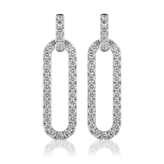 The Raffi&Co.® 14K White Gold Diamond Paper Clip Drop Earrings feature a sleek, modern design with elongated oval shapes encrusted with diamonds. Reflecting light to create a luxurious appearance, these earrings are showcased against a plain white background. They are perfect for those who appreciate the elegance of handcrafted jewelry from Raffi&Co.