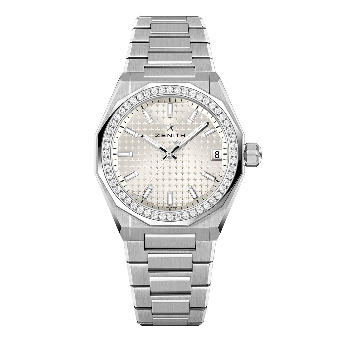 The Zenith Defy Skyline 36 Elite 670 Automatic 36mm Watch features a silver-toned textured dial, diamond-set bezel, silver hands and markers, a date window at 3 o’clock, and a stainless steel bracelet.