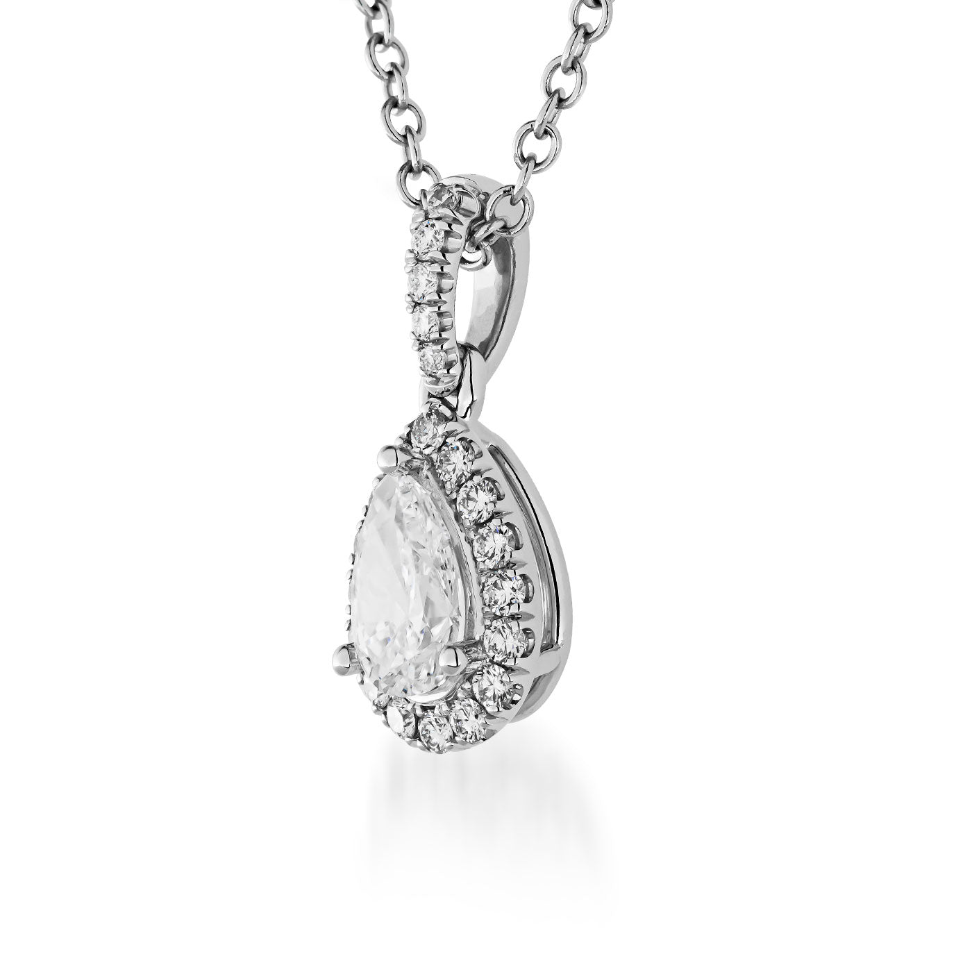 The Raffi&Co.® 14K White Gold Pear Diamond Halo Pendant Necklace showcases a luxurious white gold chain and a teardrop-shaped diamond halo pendant. In the center is an exquisite pear-cut diamond, encircled by smaller diamonds, enhancing its elegance against the plain white background.