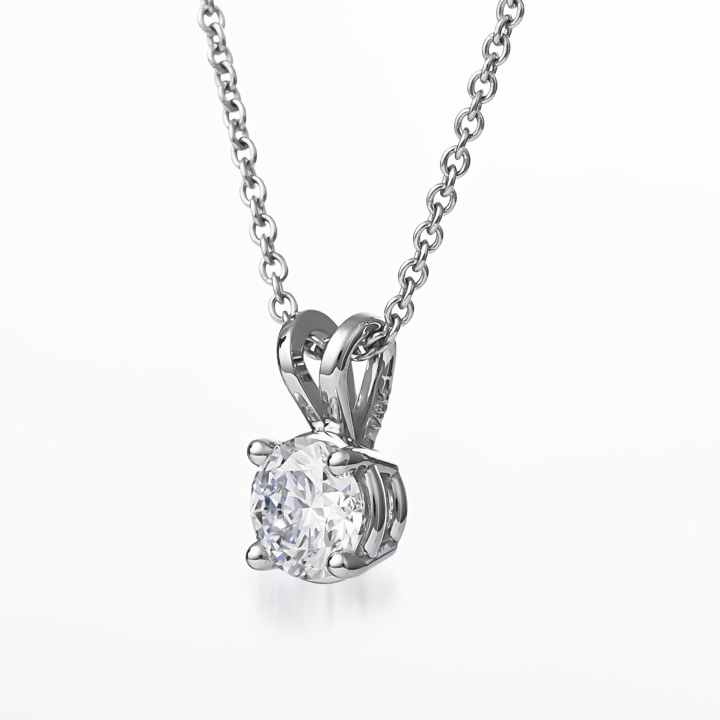 Presenting the Raffi&Co.® 14K White Gold Round Brilliant Lab Diamond Necklace Pendant by Raffi&Co, featuring a breathtaking round brilliant cut diamond held securely in a four-prong setting. Its delicate chain perfectly complements the dazzling gemstone, and against a plain white background, this elegant lab diamond necklace truly shines.