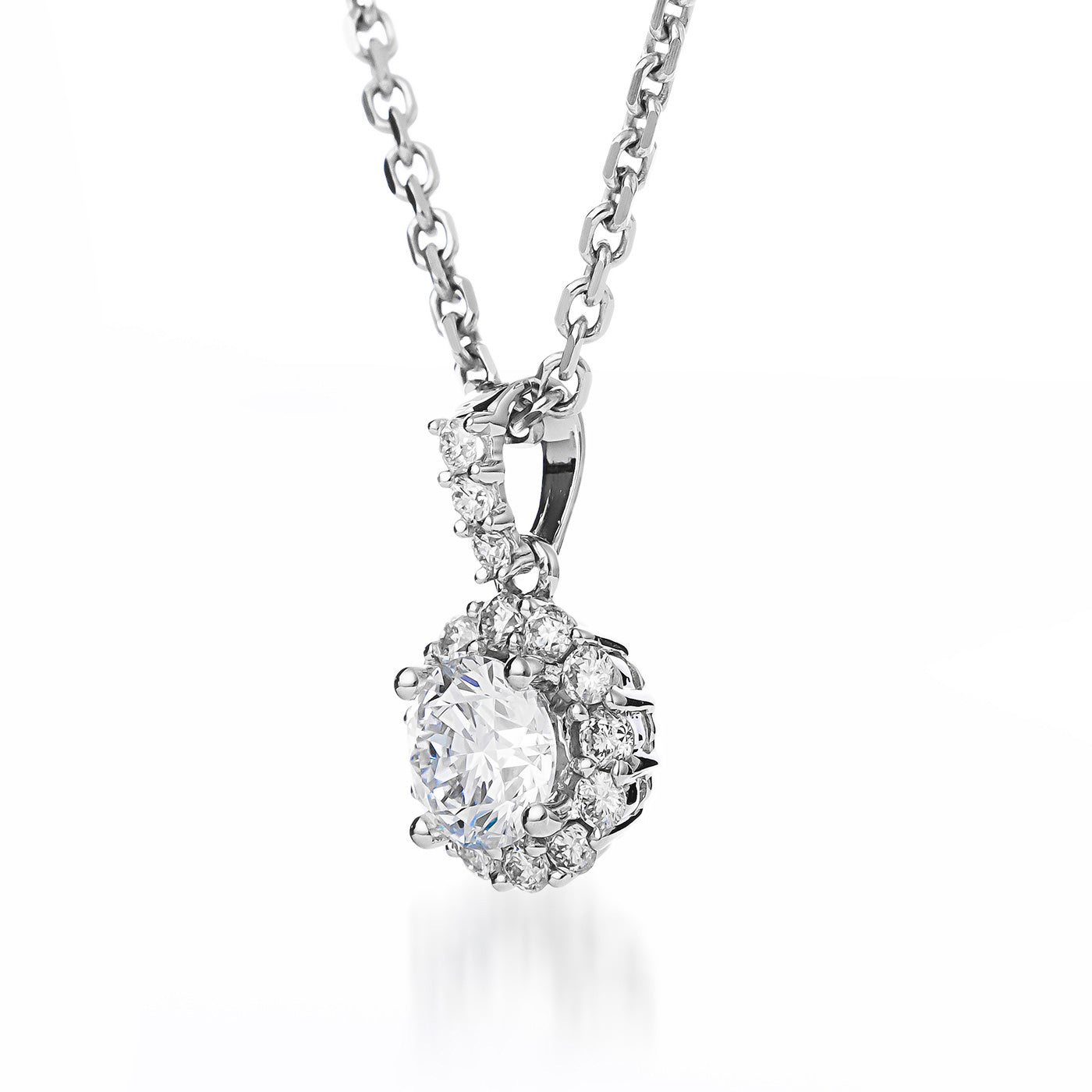 The Raffi&Co.® 18K White Gold Round Brilliant Lab Centre Diamond with Mined Accent Diamond Necklace Pendant showcases a striking round lab centre diamond encircled by mined accent diamonds, beautifully displayed on a delicate 18K white gold chain. Its brilliance shines against a plain white background, emphasizing the elegance and craftsmanship of this exquisite piece.