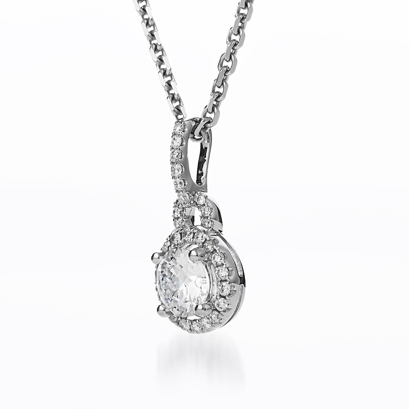 The Raffi&Co.® 18K White Gold Necklace, featuring a Round Brilliant Lab Centre Diamond Pendant adorned with mined accent diamonds, is displayed elegantly against a white background. The delicate chain enhances the stunning combination of elements presented by Raffi&Co.