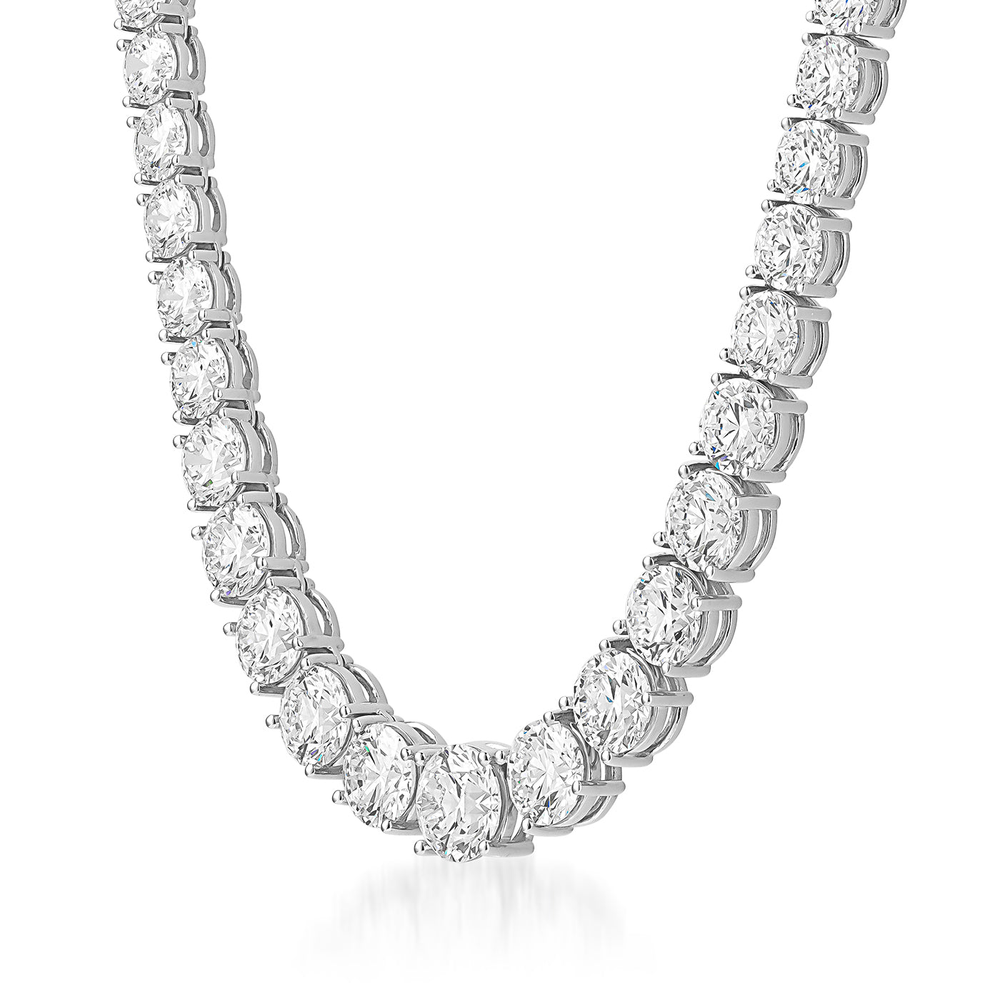 A close-up of the mesmerizing Raffi&Co.® 18K White Gold Graduated Diamond Necklace showcases the elegant drape of its large oval-shaped stones paired with round brilliant diamonds. The GIA-certified gems are set in a prong style, reflecting light to create a stunning sparkling effect.