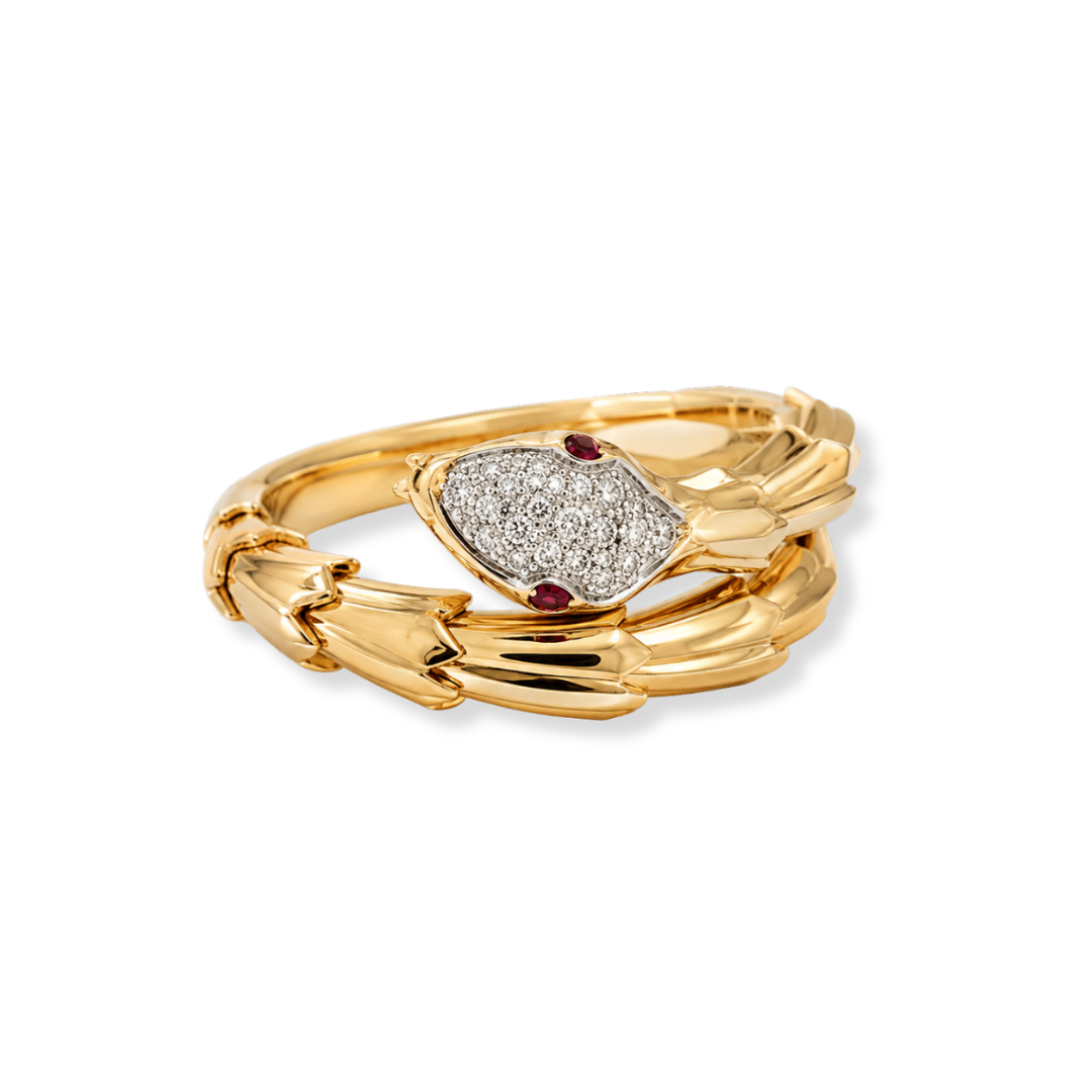 The Raffi&Co.® 18K Yellow Gold Diamond Serpent Ring by Raffi&Co features a snake-shaped design with a diamond-encrusted head set with 0.15 CTW round cut diamonds and two small red gemstone eyes, elegantly coiled in a spiral against a plain white background.