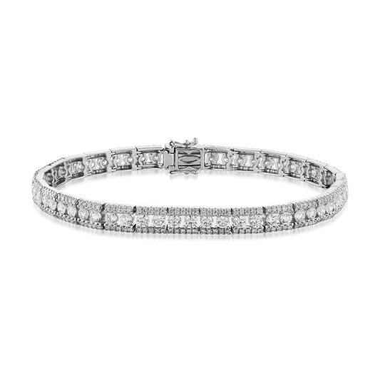 The Raffi&Co.® 18K White Gold Diamond Bracelet, by Raffi&Co, showcases a symmetrical design adorned with sparkling round diamonds set in a sleek white gold band, highlighting its elegance and luxury against a white background.