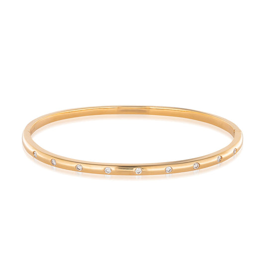 Introducing the Raffi&Co.® 18K Rose Gold Diamond Bangle, a bracelet by Raffi&Co that is embellished with small, evenly spaced diamonds across its surface. Its simple and elegant design is showcased against a plain background to emphasize its exquisite craftsmanship.