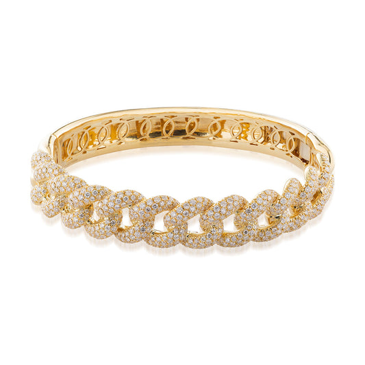 The Raffi&Co.® 18K Yellow Gold Miami Cuban Diamond Bangle, featuring a series of interlocking chain links adorned with small, sparkling diamonds, exemplifies the epitome of luxury jewelry and provides an elegant presence.