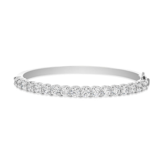 The Raffi&Co.® 14K White Gold Round Brilliant Diamond Bangle is a stunning statement piece, showcasing a continuous row of sparkling diamonds in a timeless tennis bracelet design. Its elegance and refinement shine through as it reflects light, highlighting the intricate craftsmanship against a plain white backdrop.