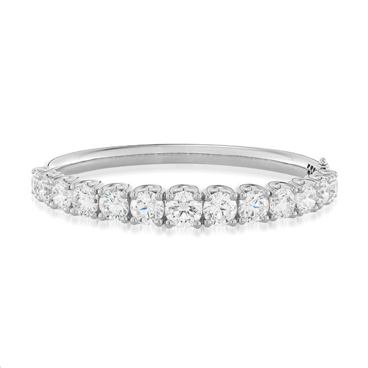 The Raffi&Co.® 18K White Gold Diamond Bangle showcases a collection of shimmering round-cut diamonds in a prong setting along its length. Its polished finish amplifies its elegance, making it an exquisite accessory presented against a white background for the Raffi&Co brand.