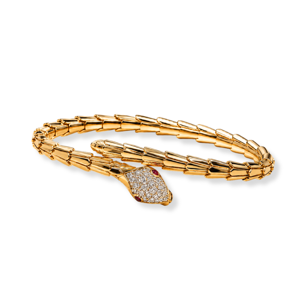 Raffi&Co.® 18K Yellow Gold Diamond Serpent Bangle featuring a textured, segmented snake-shaped band with a head adorned by round 0.16 CTW sparkling diamonds and red gem eyes, displayed on a plain white background.
