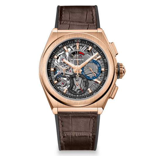 The ZENITH Defy El Primero 21 combines luxury with functionality, featuring a rose gold case and an intricate open-worked dial that reveals its mechanical inner workings. It comes with a dark brown leather strap and multiple dials and indicators on its face.