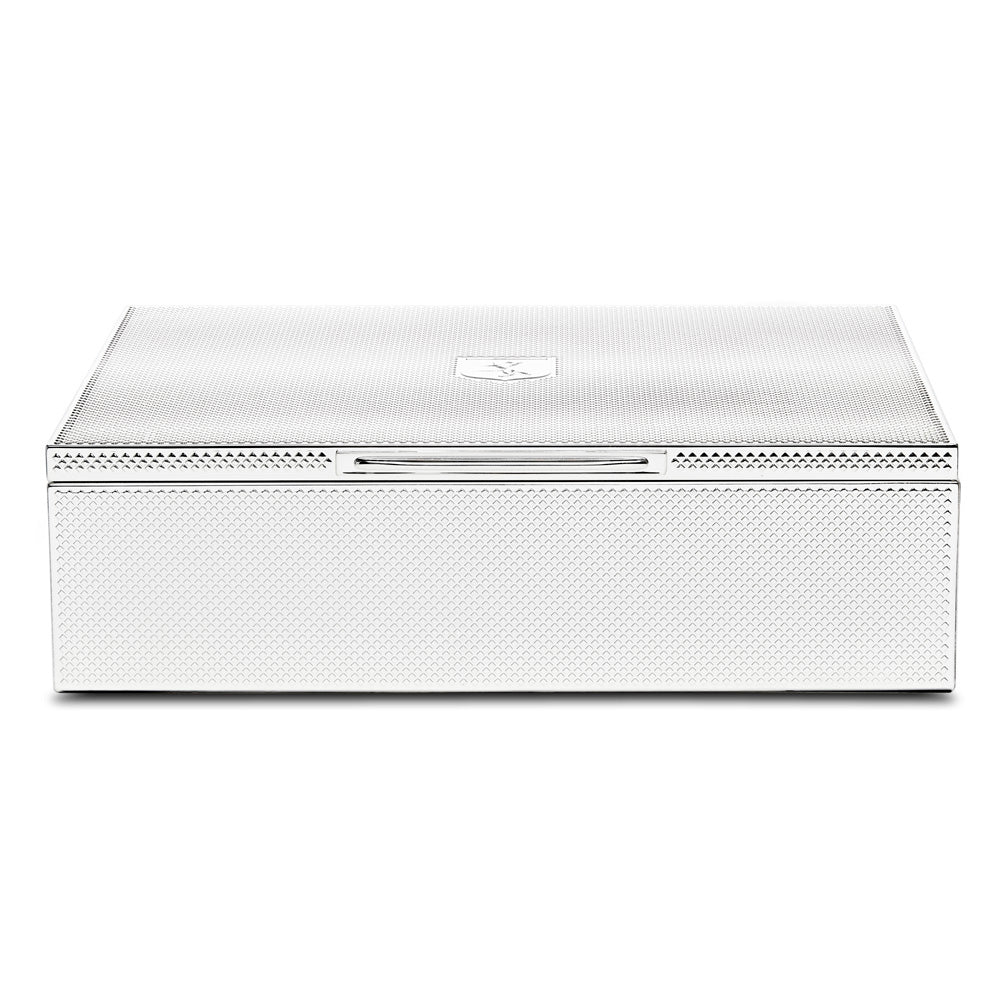 Introducing the WOLF 1834 Silver Watch Jewellery and Legacy Box by WOLF: a sleek, modern rectangular box with a hinged lid, textured silver-plating, and a subtle emblem on top. It features interior storage compartments and boasts a smooth front edge for easy opening.