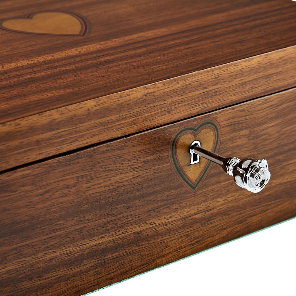 A close-up of the WOLF 1834 Ballet Musical Jewellery Box – Sleeping Beauty in walnut wood, showing a heart design with a decorative silver key inserted into a heart-shaped keyhole.