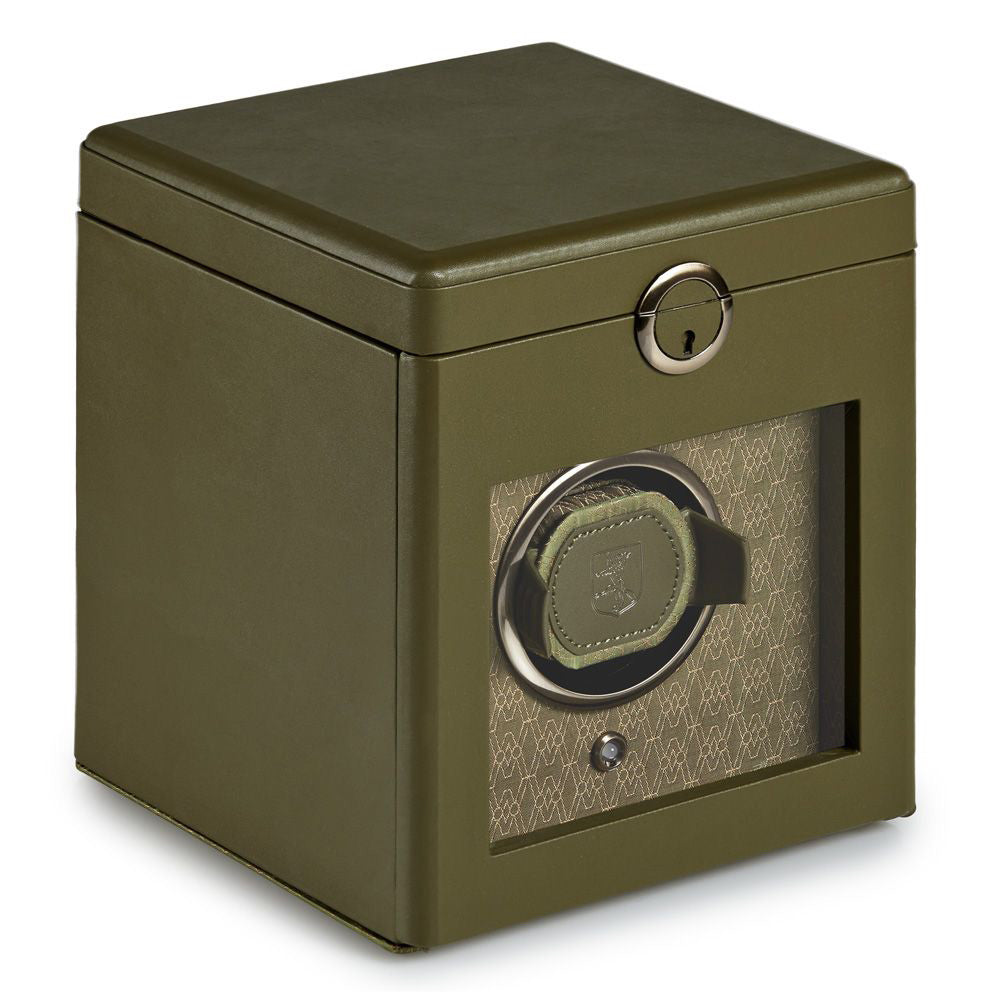 Introducing the WOLF 1834 Earth Single Watch Winder by WOLF. This innovative Bluetooth-enabled watch winder is adorned in green, boasting a transparent front panel that reveals a beautifully intricate interior design. It features a dynamic cuff and secure keyhole top, making it an exceptional patented solution for effortlessly holding and rotating a single watch.