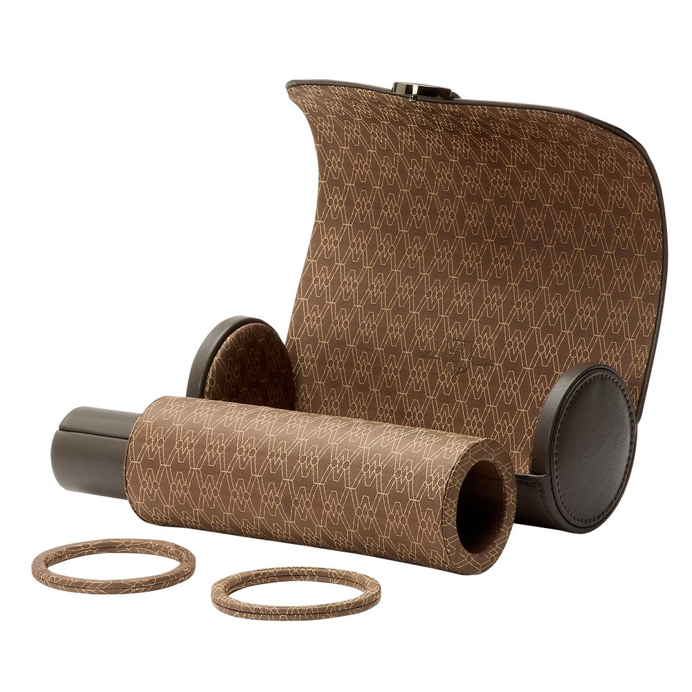 The WOLF 1834 Earth Triple Watch Roll by WOLF is a brown cylindrical case with a geometric pattern, partially open to show its interior, accompanied by two matching circular bands in front—crafted from premium apple leather.