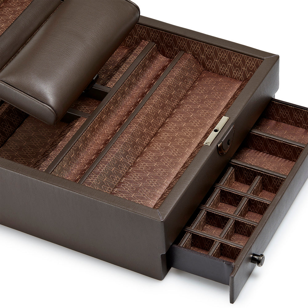 The WOLF 1834 Earth Watch Stand Box is a luxurious jewelry box crafted from dark leather and adorned with a brown patterned lining. It includes a retractable watch stand and various compartments, along with a lockable drawer featuring small sections for organizing different pieces, making it the perfect storage solution for any watch collection.