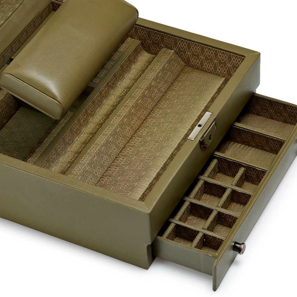 The WOLF 1834 Earth Watch Stand Box is a green leather jewelry box with an open drawer that features multiple small compartments. The main section includes cushioned slots for rings and a retractable watch stand, lined with patterned fabric. A pillow rests on top, while a keyhole adorns the front of this limited edition packaging from WOLF.