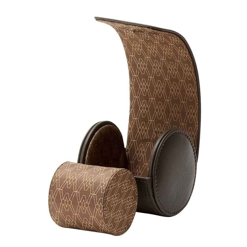 A brown, curved leather headphone stand with a geometric pattern and padded supports—perfect next to your WOLF 1834 Earth Single Watch Roll by WOLF—displayed on a white background.