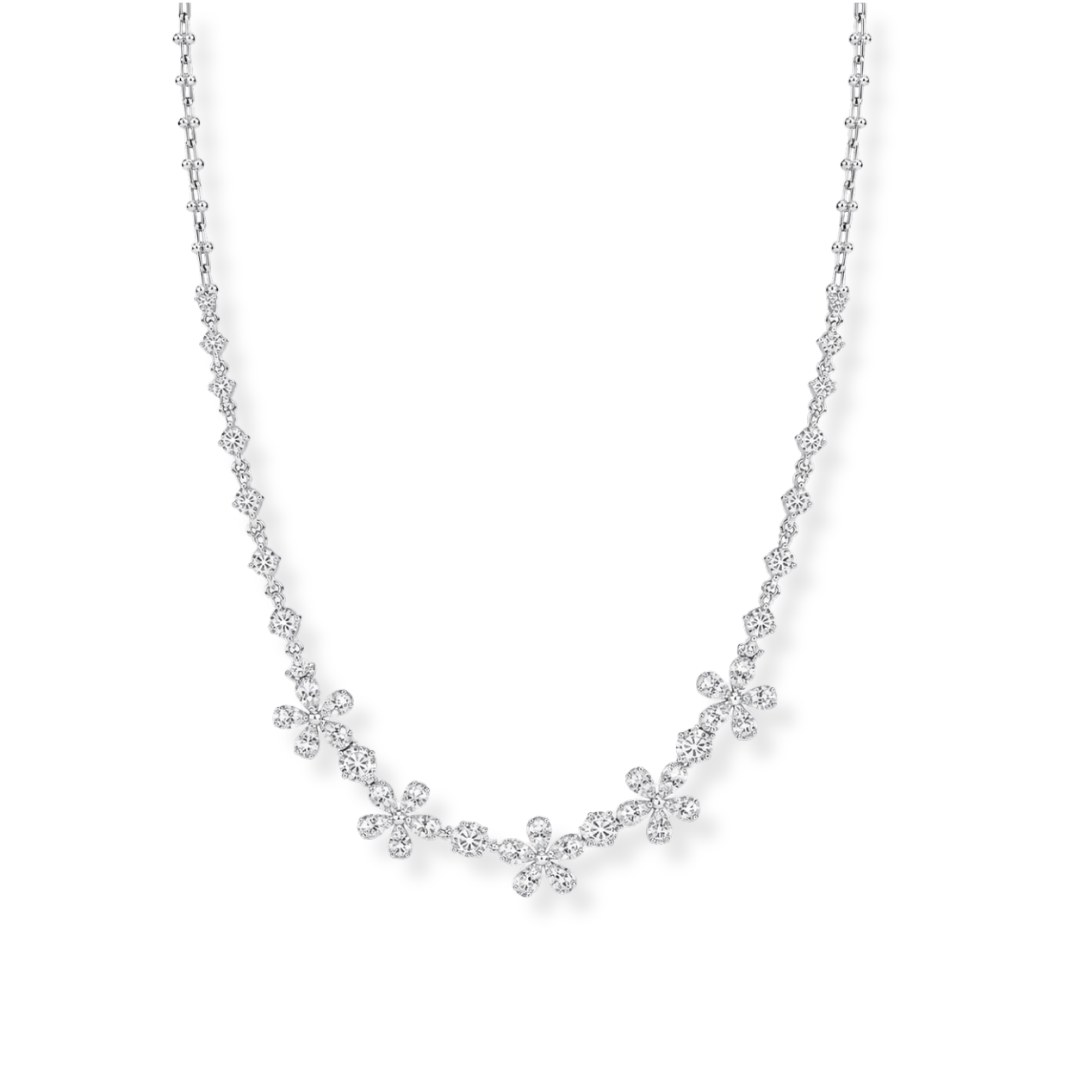 The Raffi&Co.® 18K White Gold Diamond Station Necklace by Raffi&Co features clusters of small round diamonds with SI-VS clarity, artfully arranged along a delicate white gold chain to create an elegant, floral-inspired design. The necklace showcases a total diamond weight of 8.52 CTW, with stones set in various shapes for enhanced brilliance and sophistication.