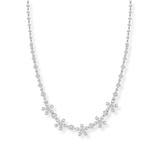 The Raffi&Co.® 18K White Gold Diamond Station Necklace by Raffi&Co features clusters of small round diamonds with SI-VS clarity, artfully arranged along a delicate white gold chain to create an elegant, floral-inspired design. The necklace showcases a total diamond weight of 8.52 CTW, with stones set in various shapes for enhanced brilliance and sophistication.
