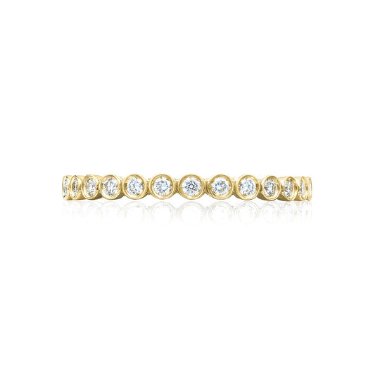 The Tacori Sculpted Crescent 18K Yellow Gold Round Brilliant Bezel Droplet Diamond Anniversary Ring showcases a series of bezel-set round brilliant diamonds that gleam against the polished gold, creating a sleek and sophisticated design. This elegant piece from Tacori is beautifully displayed on a plain white background, capturing timeless beauty and refinement.