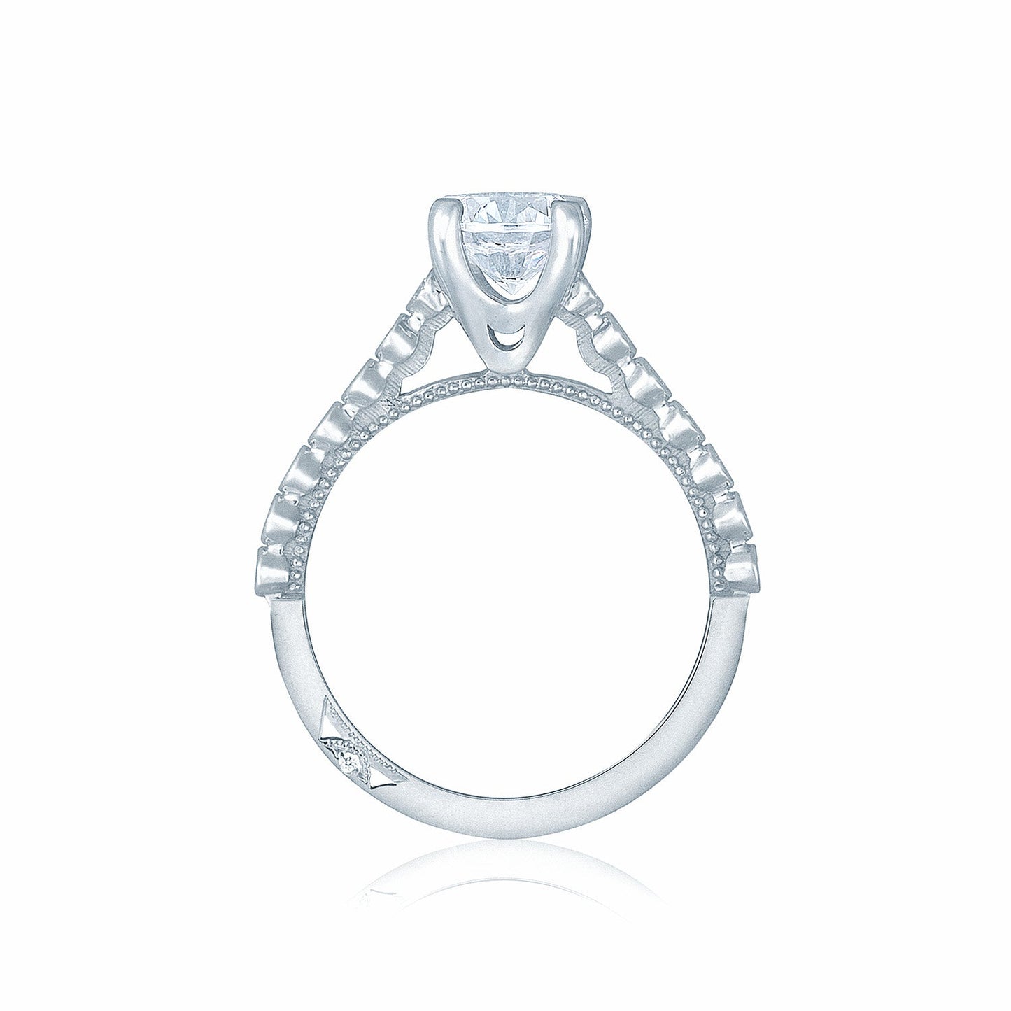 This Tacori Sculpted Crescent engagement ring features a clear round brilliant diamond set in an 18K white gold band, enhanced with intricate details and small embedded diamonds for an elegant and delicate design. The white background accentuates the ring's expert craftsmanship.
