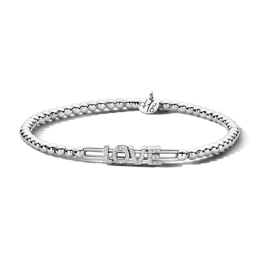 The Hulchi Belluni 18K White Gold Diamond Bracelet features a silver beaded design with "LOVE" in sparkling rhinestones and a small initial-engraved charm accented with 18K white gold near the clasp.