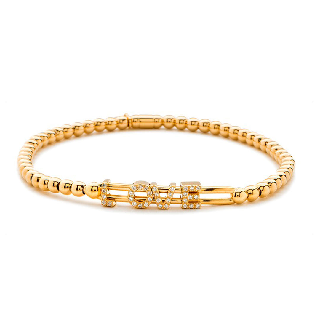 The Hulchi Belluni 18K Yellow Gold Diamond Bracelet showcases the word "LOVE" in capital letters, each accented with sparkling diamonds for a dazzling effect.