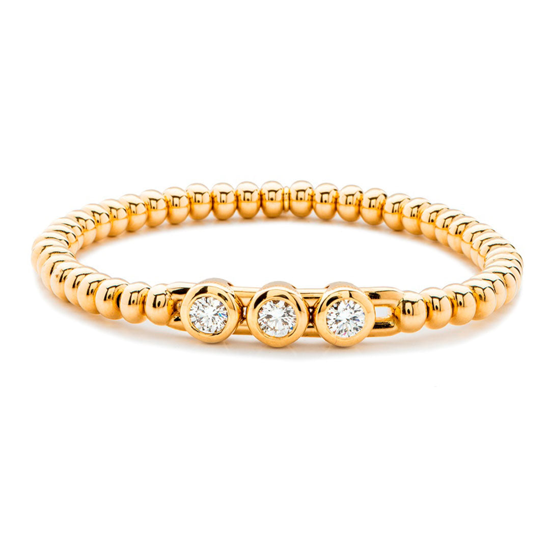 The Hulchi Belluni Tresore Bracelet by Hulchi Belluni is crafted in 18K yellow gold and features three round brilliant bezel-set diamonds totaling 0.90 CTW, shown on a white background.