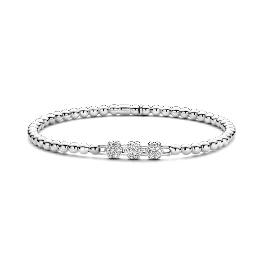 The Hulchi Belluni 18K White Gold Diamond Bracelet by Hulchi Belluni features three flower-shaped charms with sparkling stones totaling 0.22 CTW, displayed on a white background.