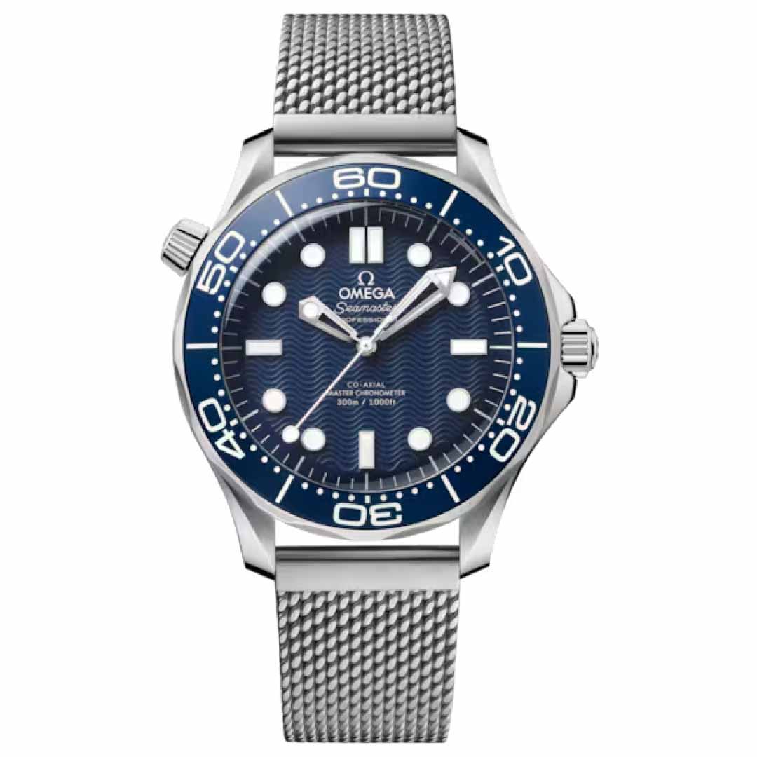 The OMEGA Seamaster Diver 300M James Bond 60th Anniversary Co-Axial Master Chronometer 42mm Watch features a silver case with a blue dial showcasing a wave pattern. It is powered by the Master Chronometer Calibre 8806 and includes a stainless steel mesh strap, date display, luminescent hour markers, and minute numerals on the bezel, capturing the essence of true James Bond style.