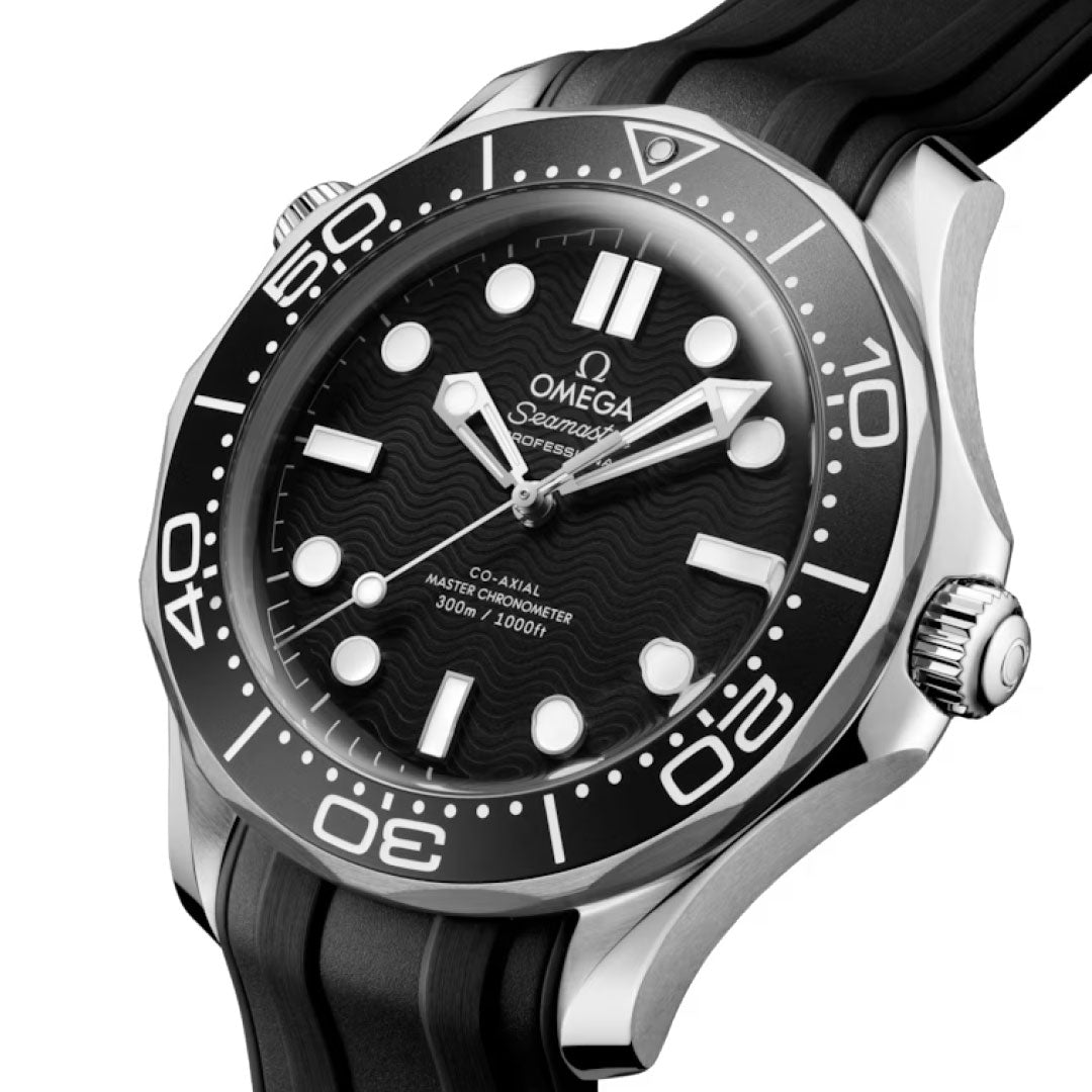 A close-up of the OMEGA Seamaster Diver 300M Co-Axial Master Chronometer 42mm shows a black dial with white Super-LumiNova indices, rotating bezel, black rubber strap, silver-tone accents, and water resistance up to 300 meters.