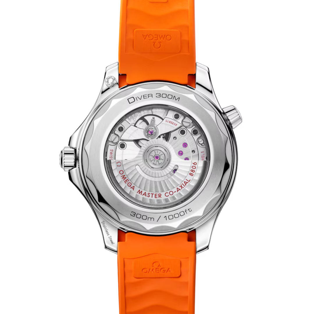 Back view of the OMEGA Seamaster Diver 300M Co-Axial Master Chronometer 42mm Watch with orange rubber strap, showing the exposed Master Chronometer movement through a transparent case back marked “Diver 300M” and “Omega Master Co-Axial 8800.”.