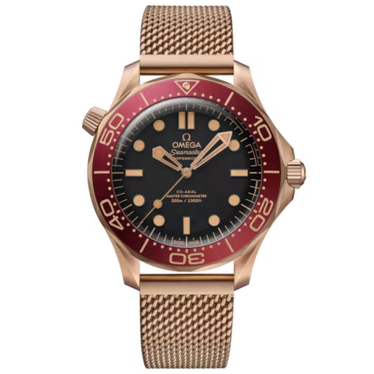 An OMEGA Seamaster Diver 300M Co-Axial Master Chronometer 42mm Watch with a Bronze Gold case, red bezel, black dial, gold hour markers, and bronze mesh strap is displayed against a white background.