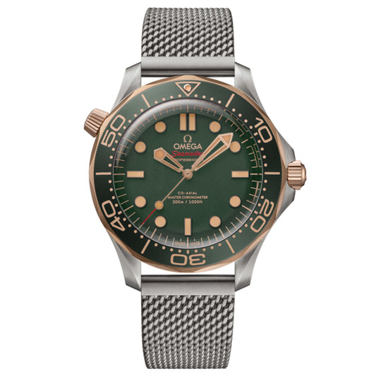 The OMEGA Seamaster Diver 300M Co-Axial Master Chronometer 42mm watch boasts a green face with gold accents, large numerals, and a round bezel with minute markers. Made of 9K Bronze Gold, it features a mesh silver strap, date window at 6 o'clock, crown at 3 o'clock, and helium escape valve at 10.