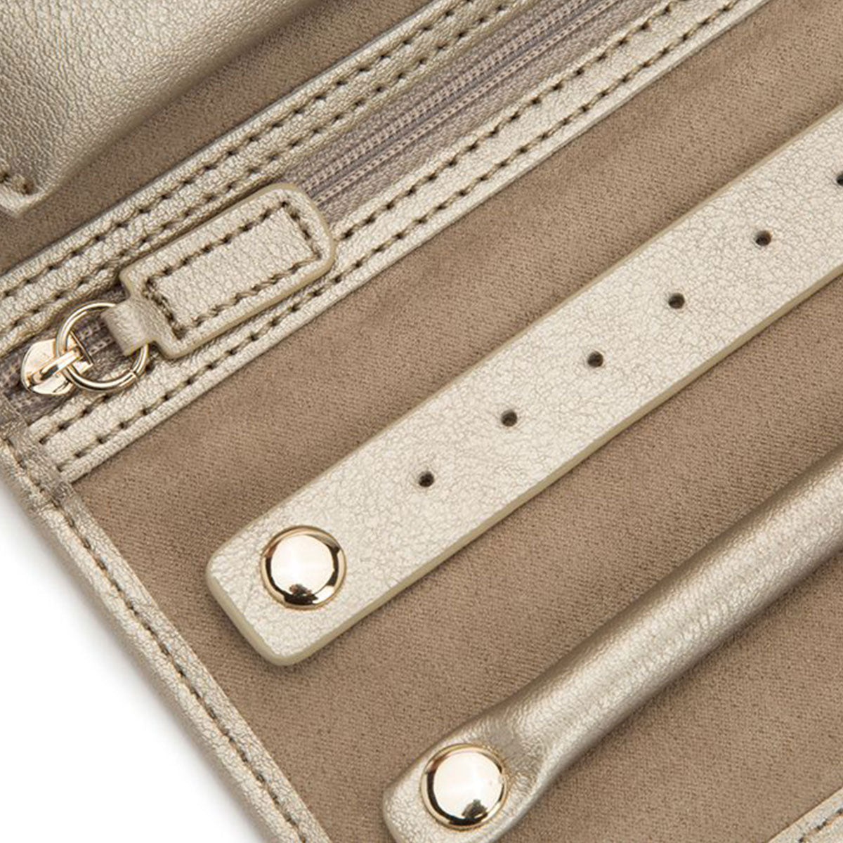 Close-up of the WOLF 1834 Palermo Jewellery Roll in beige leather, showcasing a zipper pocket and two metallic snap-button straps along with an anti-tarnish lining. The texture of the leather exterior is visible, and the jewellery roll is open, highlighting its interior design ideal for travel storage.