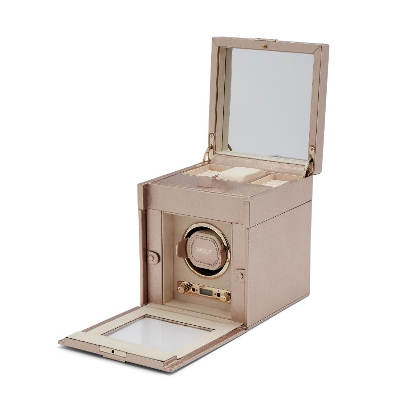 The WOLF 1834 Palermo Single Winder With Jewellery Storage by WOLF is designed in elegant rose gold, featuring an open lid and front panel that reveals a beige fabric interior. This watch winder provides rotation options visible through its glass panel and offers space on top for additional small items, adding to the refined display.