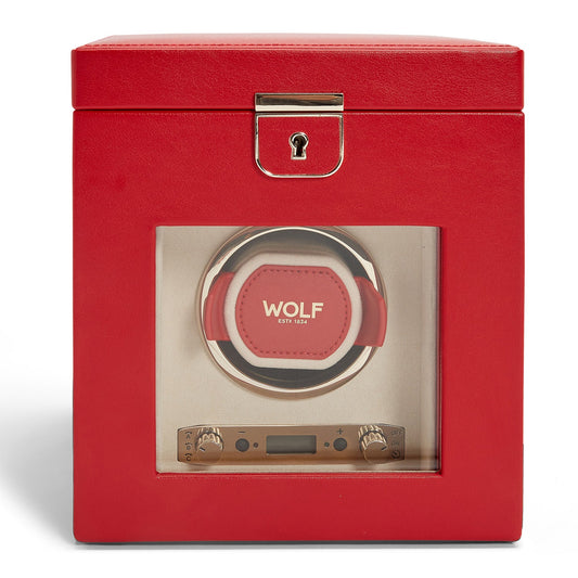 A red leather WOLF 1834 Palermo Single Watch Winder with Jewellery Storage, featuring a transparent front panel, beautifully displays a watch holder. The box includes a latch on top, proudly presenting "WOLF" on the holder, and is equipped with buttons below to set the power reserve.
