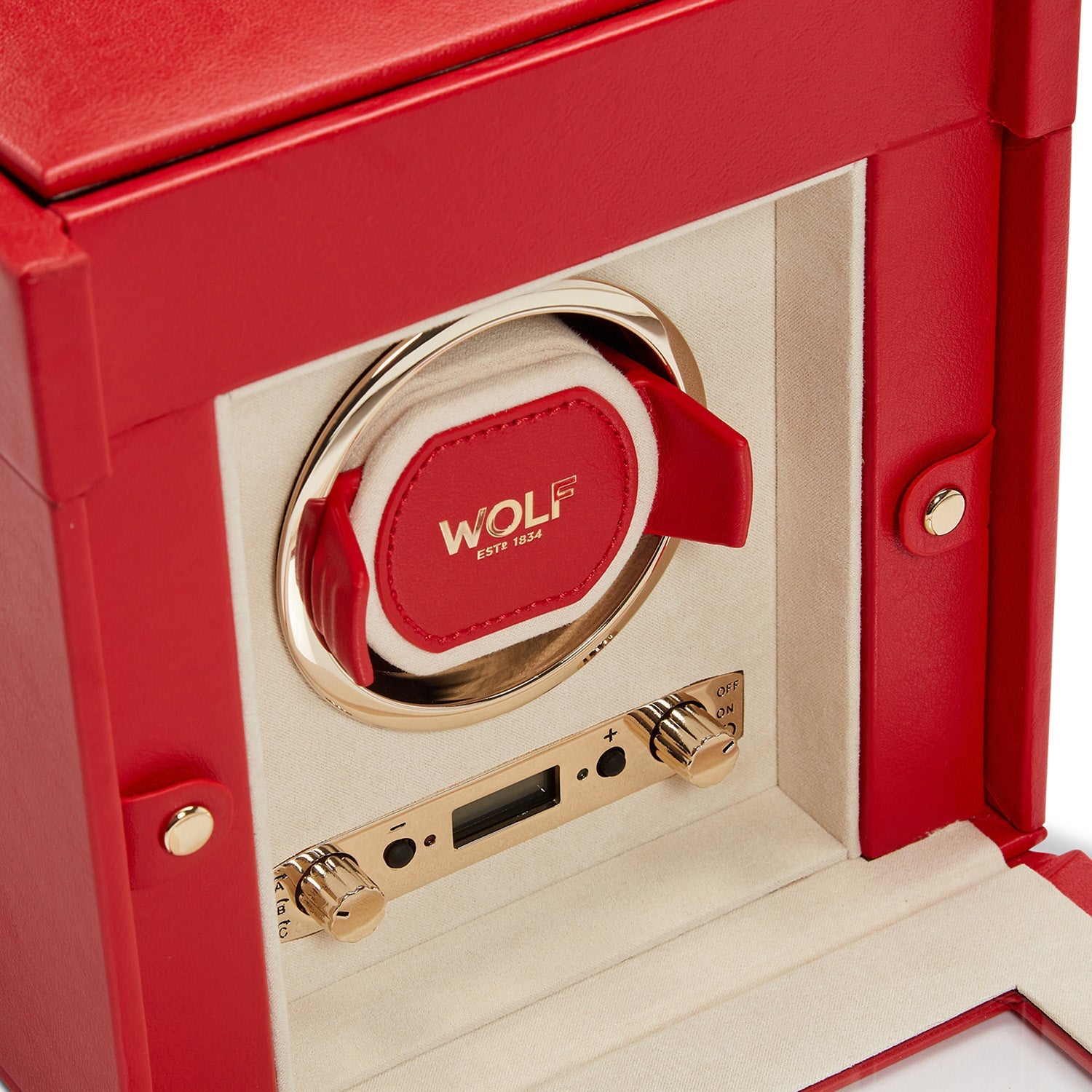 The WOLF 1834 Palermo Single Watch Winder with Jewellery Storage combines a stunning red and beige design with gold accents and prominently displays the brand name in the center. Its interior features a lock-in dynamic cuff, power reserve setting, and control knobs accented by "EST. 1834," exemplifying its luxurious and elegant craftsmanship.