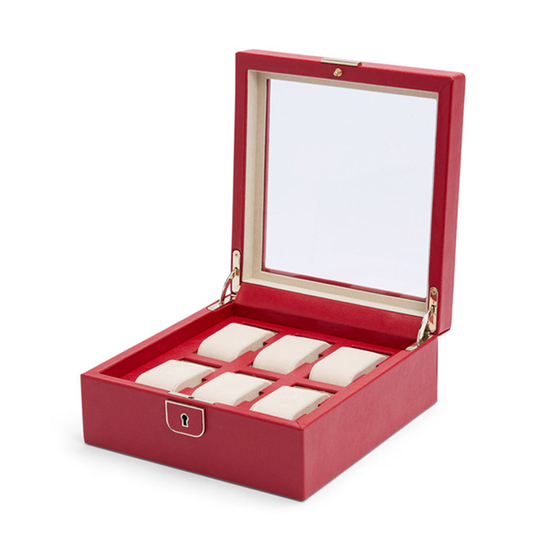 The WOLF 1834 Palermo 6 Piece Watch Box, in red with a transparent lid, is open to reveal its beige interior. It features six individual compartments with cushions for watches and includes a front keyhole for added security.