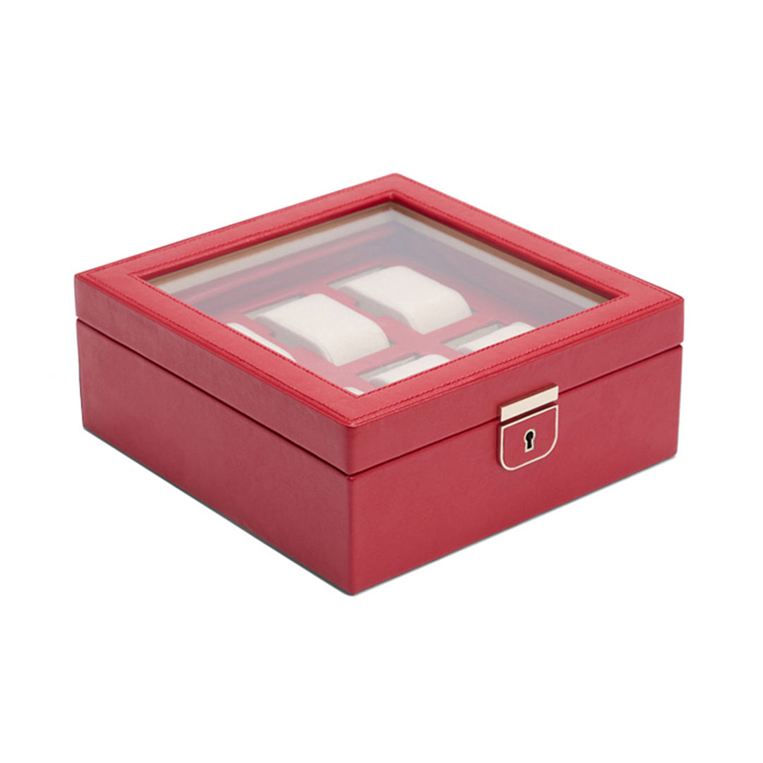 The WOLF 1834 Palermo 6 Piece Watch Box, by WOLF, is a red jewelry box with a glass top and a secure front lock. It showcases an interior with watch compartments lined in white fabric for storage.