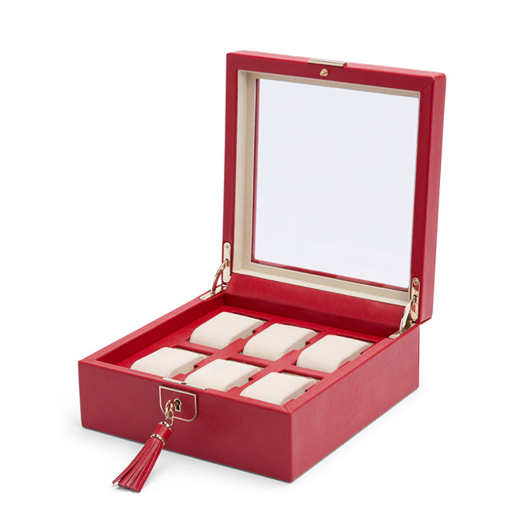 The WOLF 1834 Palermo 6 Piece Watch Box is a striking accessory, featuring a red exterior with a glass lid. Inside, six watch compartments are lined in cream fabric. It includes a red tassel on the front latch and provides lock and key security for peace of mind.