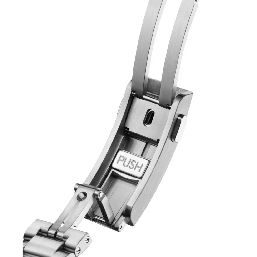 Close-up of the OMEGA Seamaster Planet Ocean 6000M Ultra Deep Co-Axial Master Chronometer 45.5mm's stainless steel clasp, partially open to show its "PUSH" release button, hinges, and locking mechanism against a white background.